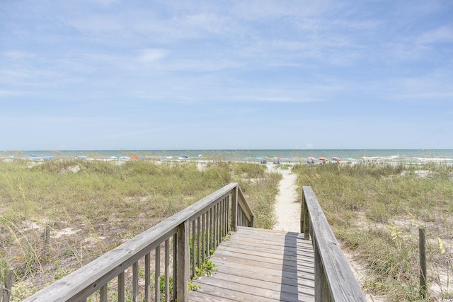 view of community with a beach view and a water view