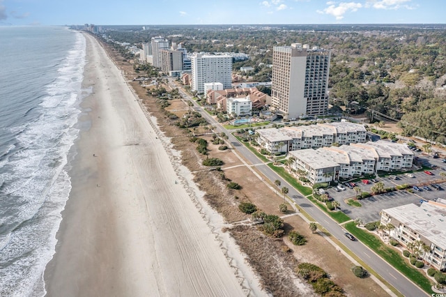 birds eye view of property featuring a water view and a beach view