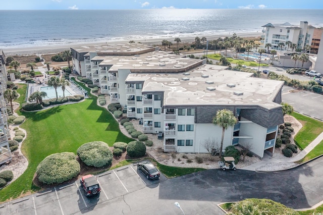 drone / aerial view with a water view and a view of the beach