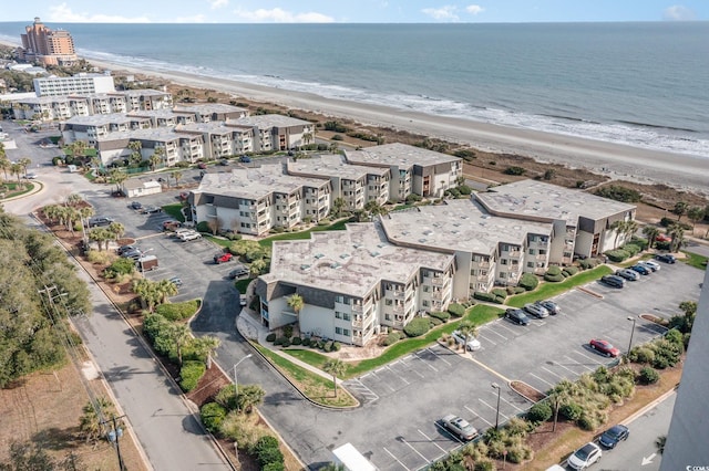 drone / aerial view featuring a beach view and a water view