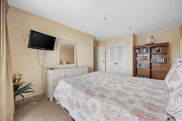 tiled bedroom with a closet