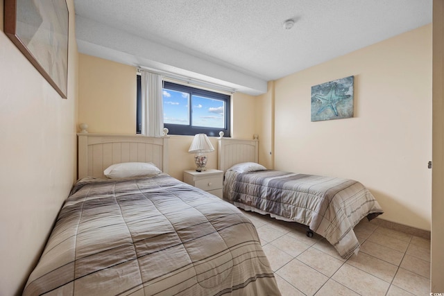 tiled bedroom with a textured ceiling