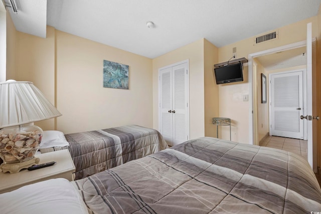 tiled bedroom featuring a closet