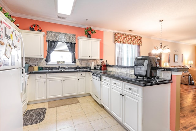 kitchen featuring white cabinets, kitchen peninsula, and white appliances