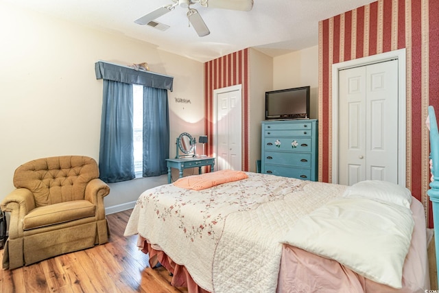 bedroom with ceiling fan and wood-type flooring