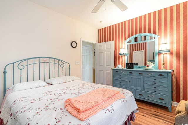 bedroom with ceiling fan and light hardwood / wood-style flooring