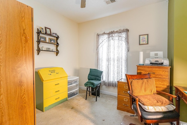 living area with ceiling fan and light colored carpet