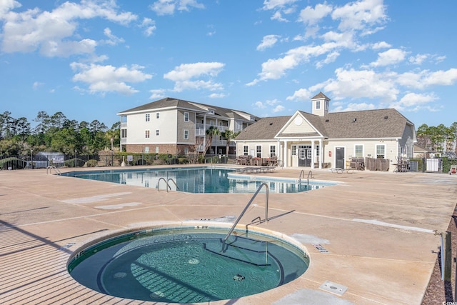 view of pool featuring a hot tub and a patio area