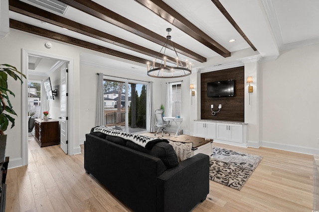 living room with an inviting chandelier, light hardwood / wood-style flooring, plenty of natural light, and crown molding