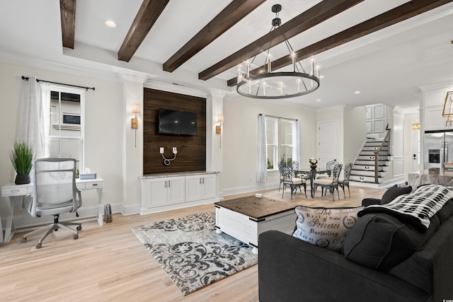 living room with beamed ceiling, a notable chandelier, light wood-type flooring, and crown molding