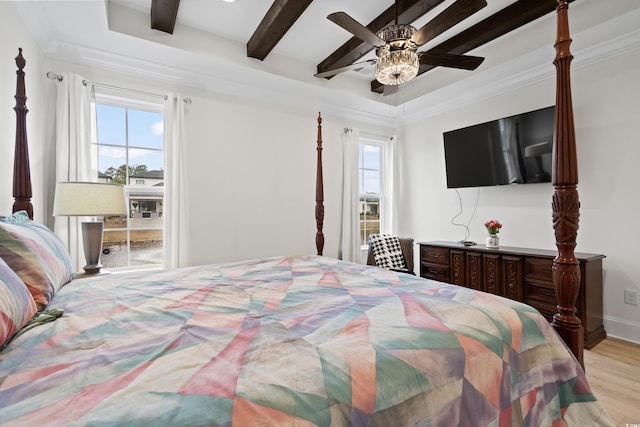 bedroom with multiple windows, light hardwood / wood-style floors, ceiling fan, and crown molding