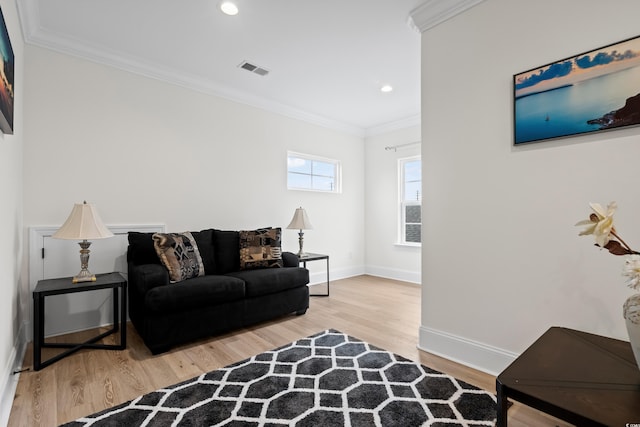 living room with hardwood / wood-style flooring and crown molding