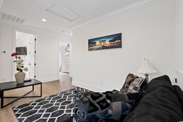 living room featuring hardwood / wood-style floors and crown molding