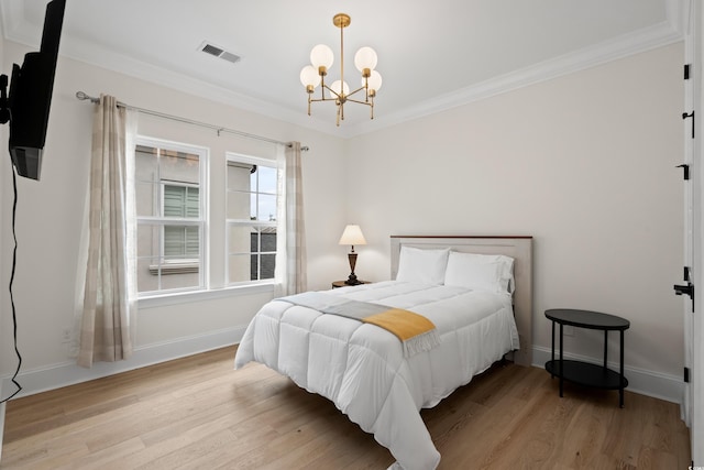 bedroom featuring crown molding, light hardwood / wood-style flooring, and a notable chandelier