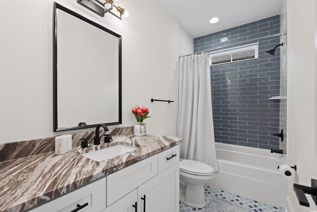 full bathroom featuring tile patterned floors, shower / bath combo with shower curtain, vanity, and toilet