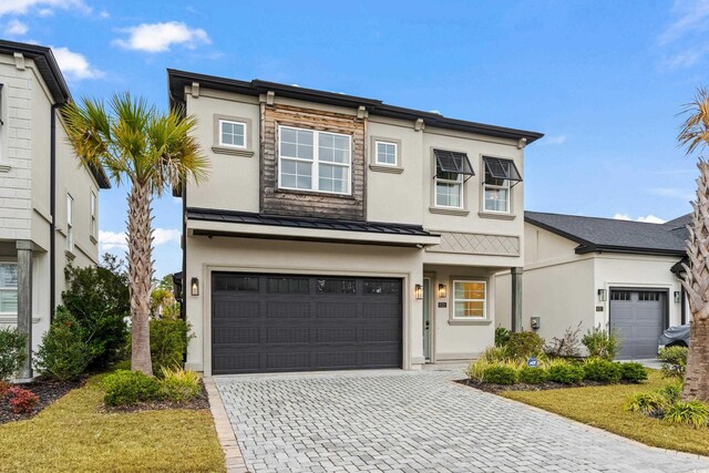 view of front of house featuring a front yard and a garage