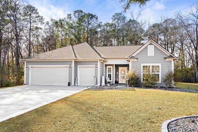 ranch-style home with a garage and a front lawn