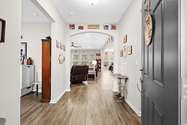 foyer entrance with hardwood / wood-style floors and ceiling fan