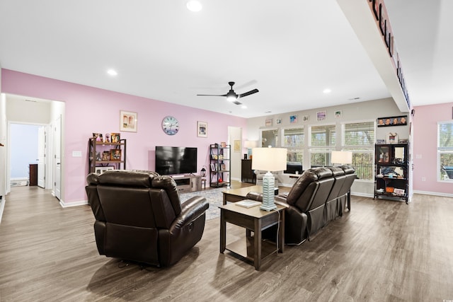 living room with hardwood / wood-style floors and ceiling fan