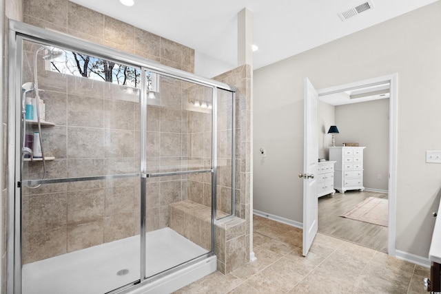 bathroom featuring a shower with door