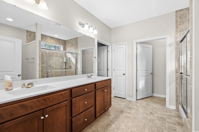 bathroom with vanity and a shower with shower door