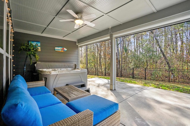 sunroom / solarium featuring ceiling fan and a hot tub