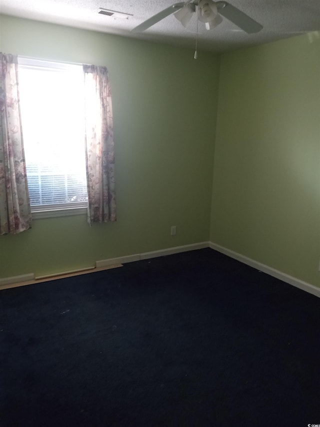 unfurnished room featuring a textured ceiling and ceiling fan