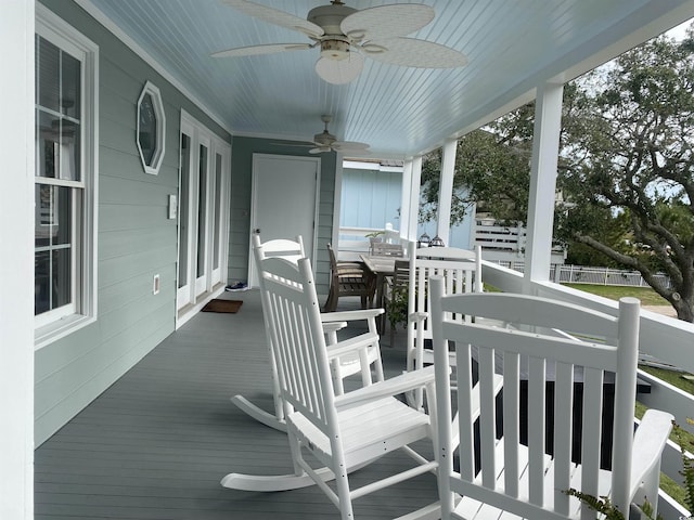 wooden terrace featuring ceiling fan and a porch