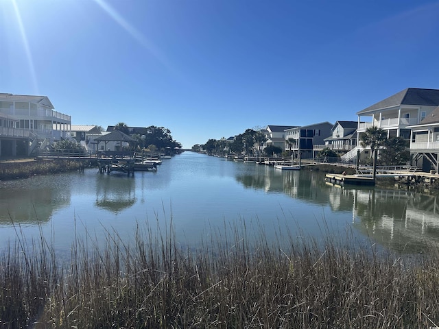 view of water feature with a residential view and a boat dock