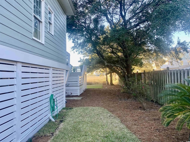 view of yard with stairway and a fenced backyard