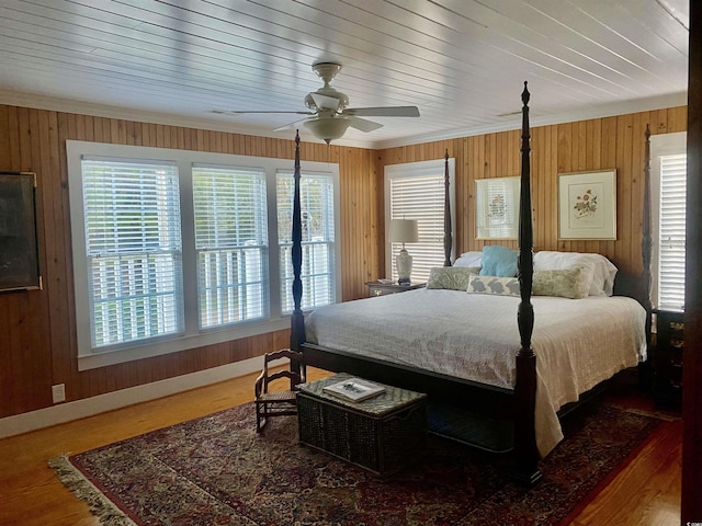 bedroom featuring ceiling fan, ornamental molding, and hardwood / wood-style floors