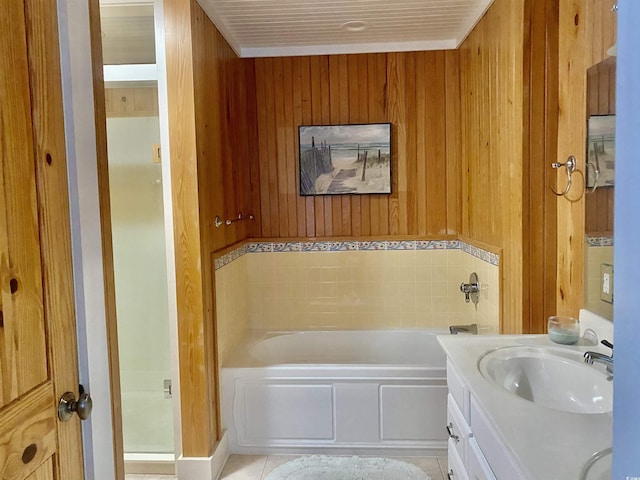 bathroom featuring vanity, a bath, wooden walls, and tile patterned floors