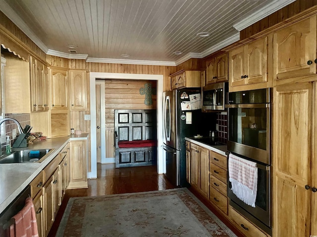 kitchen featuring dark wood-type flooring, a sink, appliances with stainless steel finishes, wooden ceiling, and crown molding