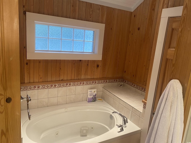 bathroom featuring a tub to relax in and wood walls