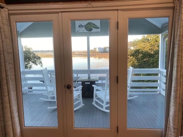 doorway to outside featuring a water view and french doors