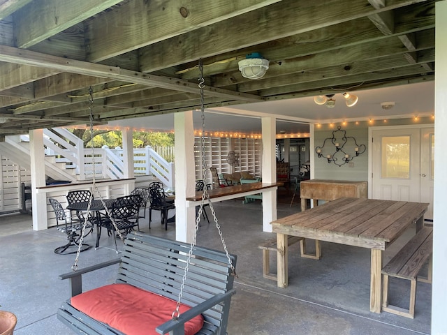 view of patio featuring outdoor dining space and stairs