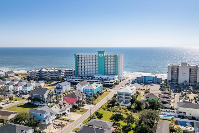 birds eye view of property featuring a water view and a view of city