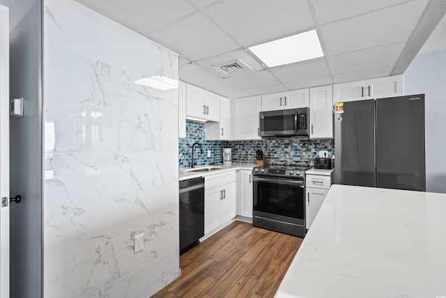 kitchen featuring range with electric stovetop, visible vents, freestanding refrigerator, dishwasher, and stainless steel microwave