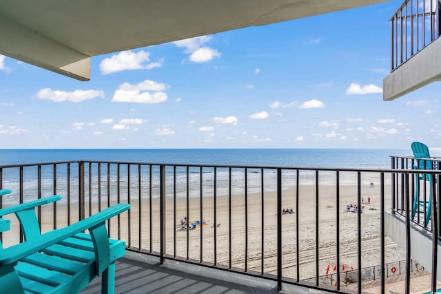 balcony featuring a water view and a beach view