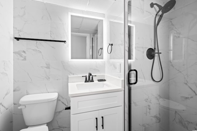 bathroom featuring toilet, vanity, and a marble finish shower