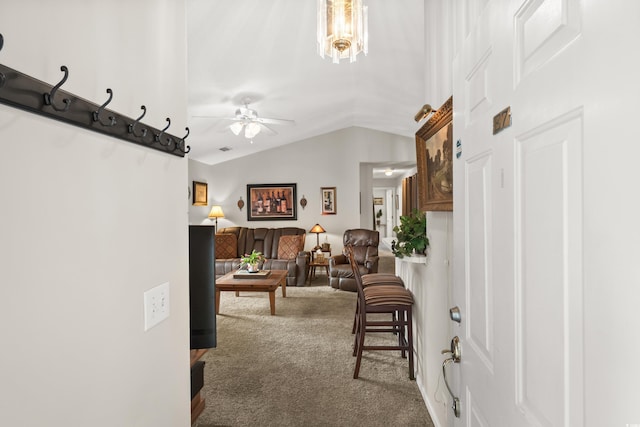 living room featuring carpet flooring, ceiling fan with notable chandelier, and lofted ceiling