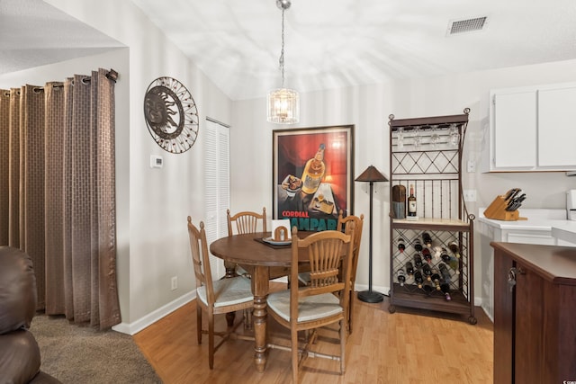 dining room featuring light hardwood / wood-style floors and an inviting chandelier