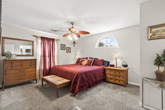 carpeted bedroom with a textured ceiling and ceiling fan