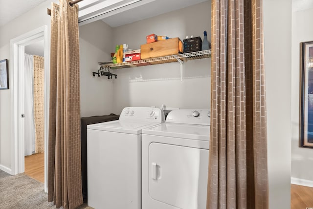 clothes washing area featuring carpet flooring and independent washer and dryer