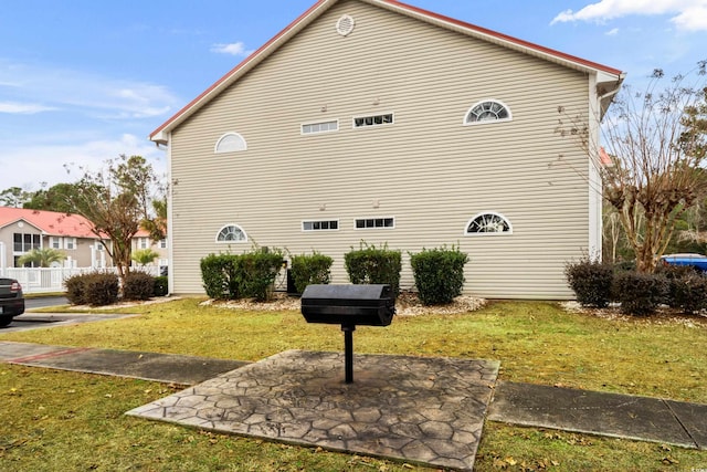 view of property exterior featuring a yard and a patio