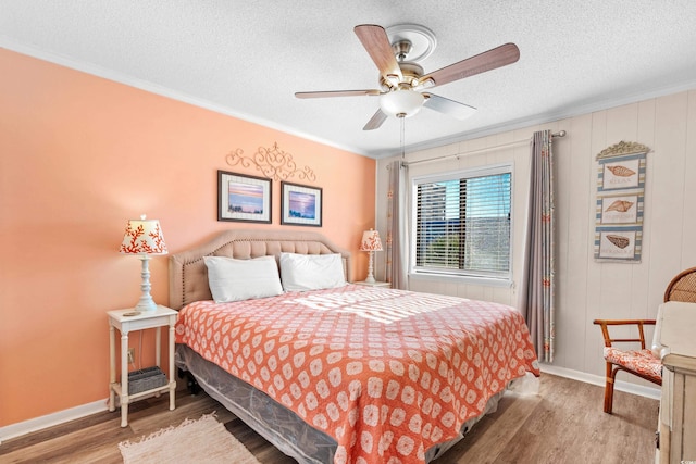 bedroom featuring wood-type flooring, ceiling fan, and ornamental molding