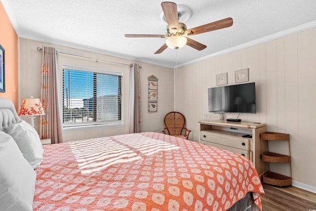 bedroom featuring ceiling fan, dark wood-type flooring, a textured ceiling, and ornamental molding