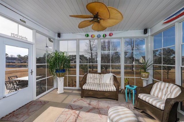 sunroom featuring ceiling fan and wooden ceiling