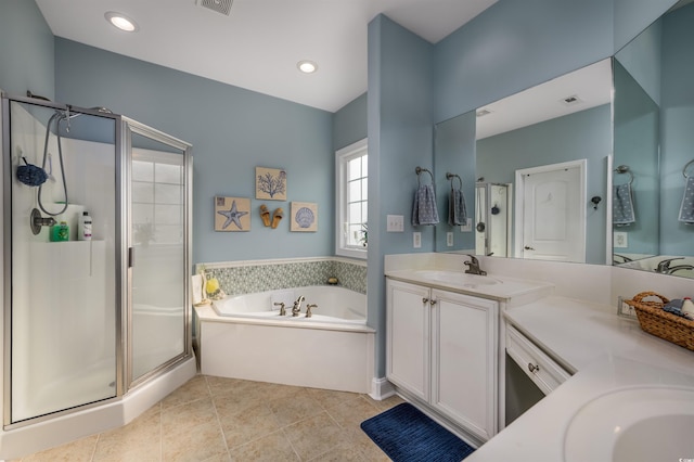 bathroom featuring plus walk in shower, vanity, and tile patterned floors