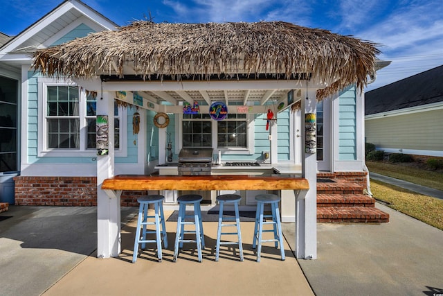 view of patio / terrace with exterior bar and grilling area